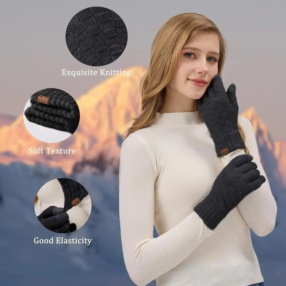 Woman in a cream sweater wearing charcoal REACH STAR knit touchscreen gloves in front of snowy mountains